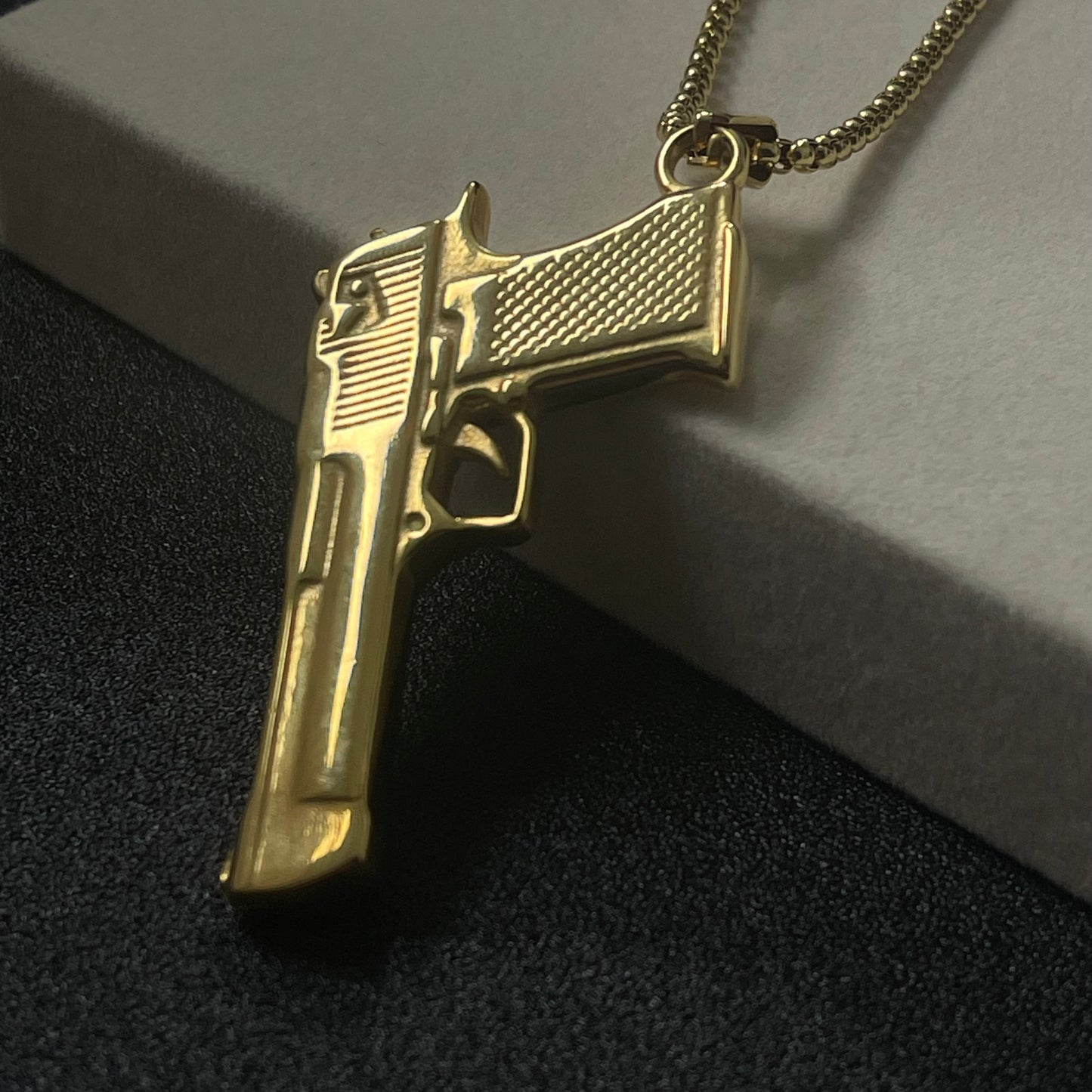 golden pistol rifle pendant necklace for men online in pakistan