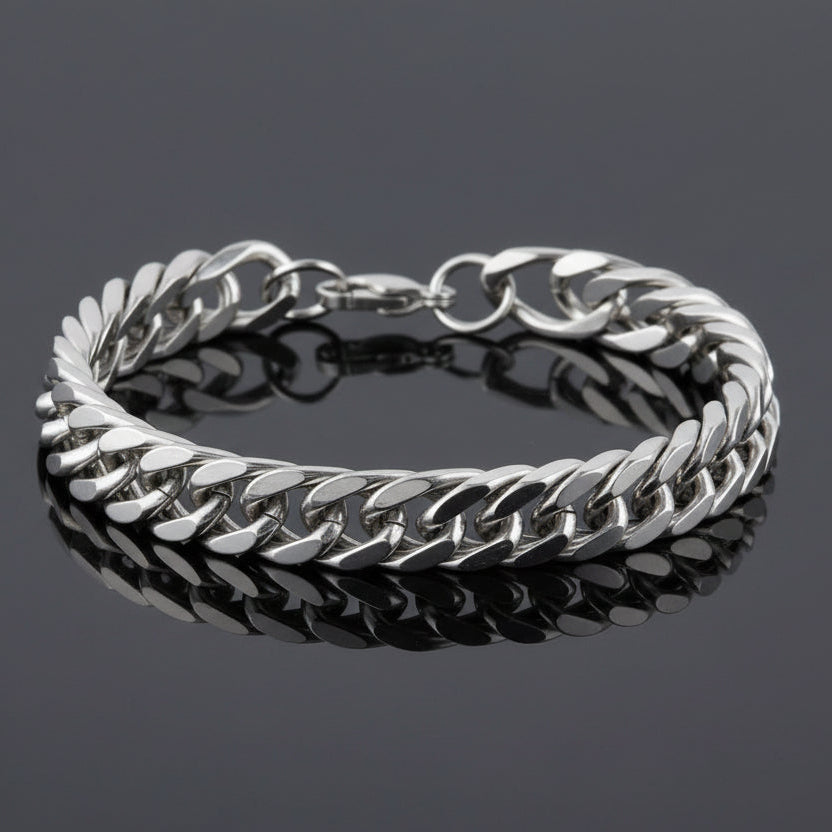 Silver chain bracelet on a reflective black surface