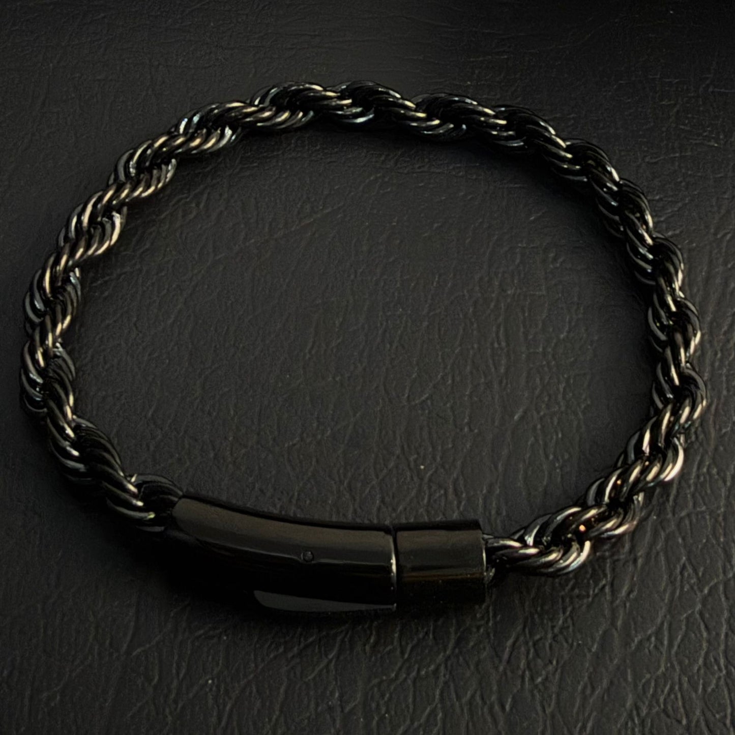 Close-up of black electroplated rope chain bracelet clasp and link detail