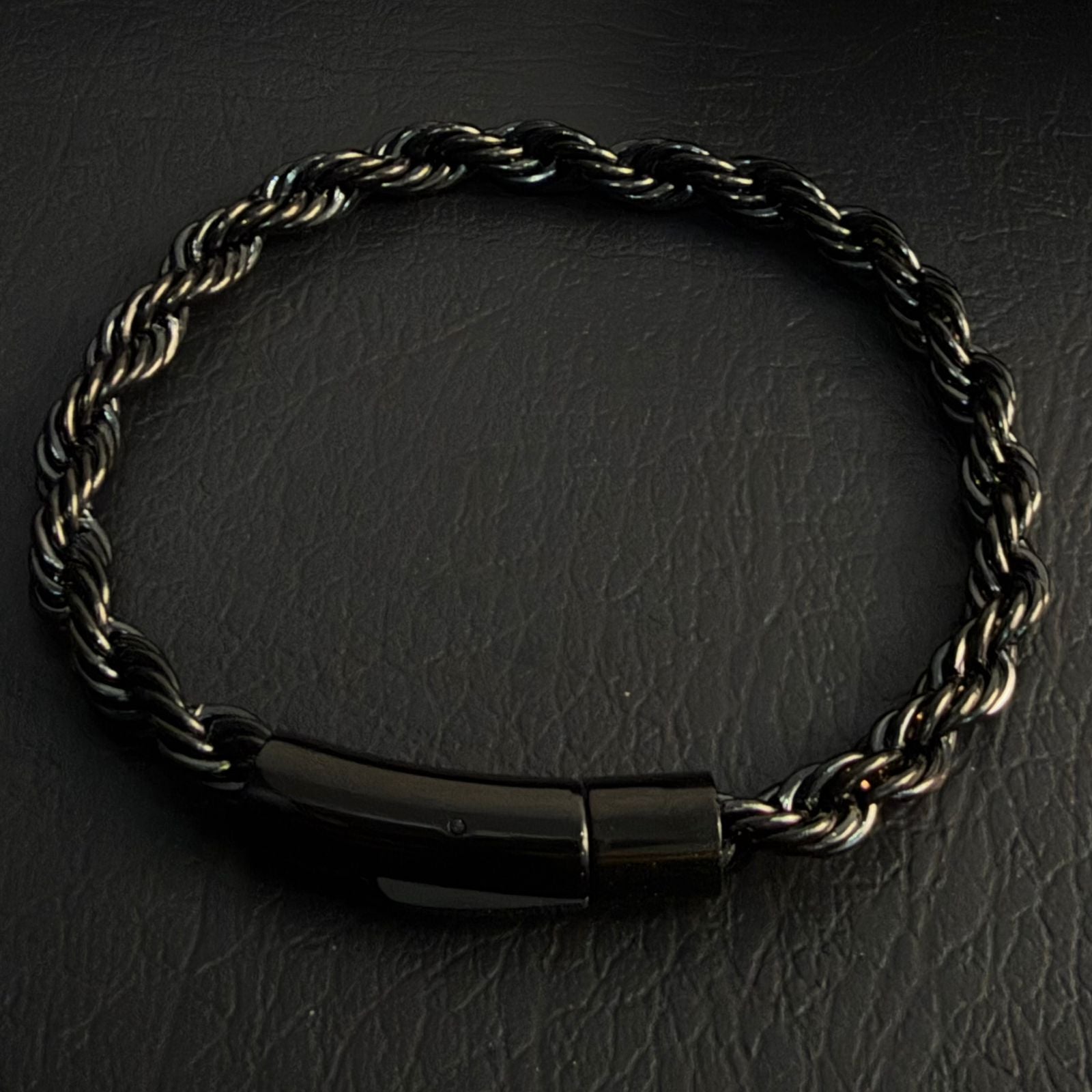 Close-up of black electroplated rope chain bracelet clasp and link detail