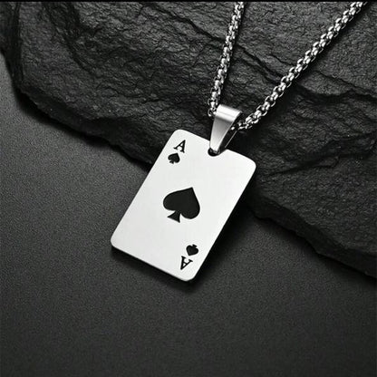 Silver ace of spades necklace on a dark stone background