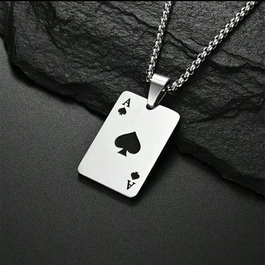 Silver ace of spades necklace on a dark stone background