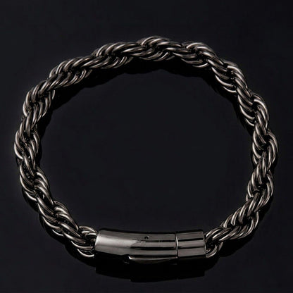 A dark metallic twisted rope chain bracelet with a polished cylindrical clasp, displayed on a solid black background.